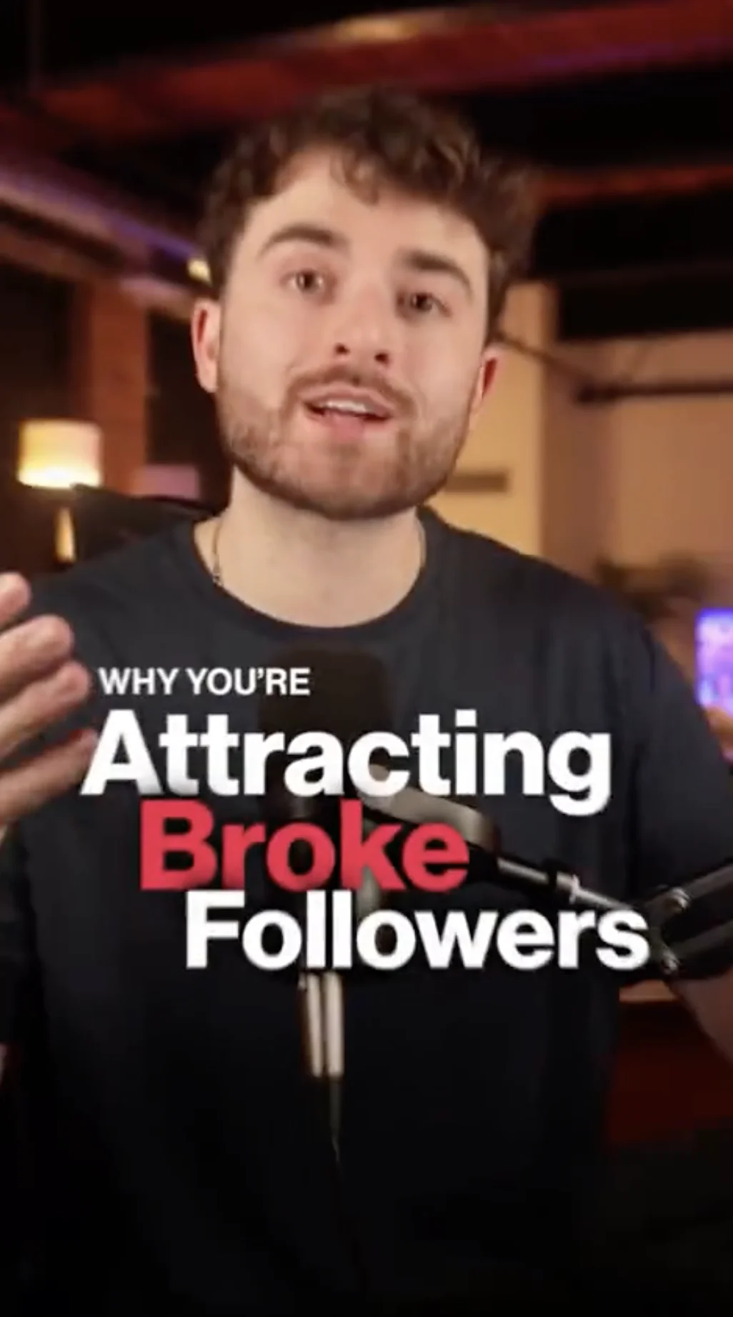 Vertical opening frame from the 81-second video: bold typography reading "WHY YOU'RE Attracting Broke Followers" over the presenter speaking into a podcast microphone in a warmly lit studio.